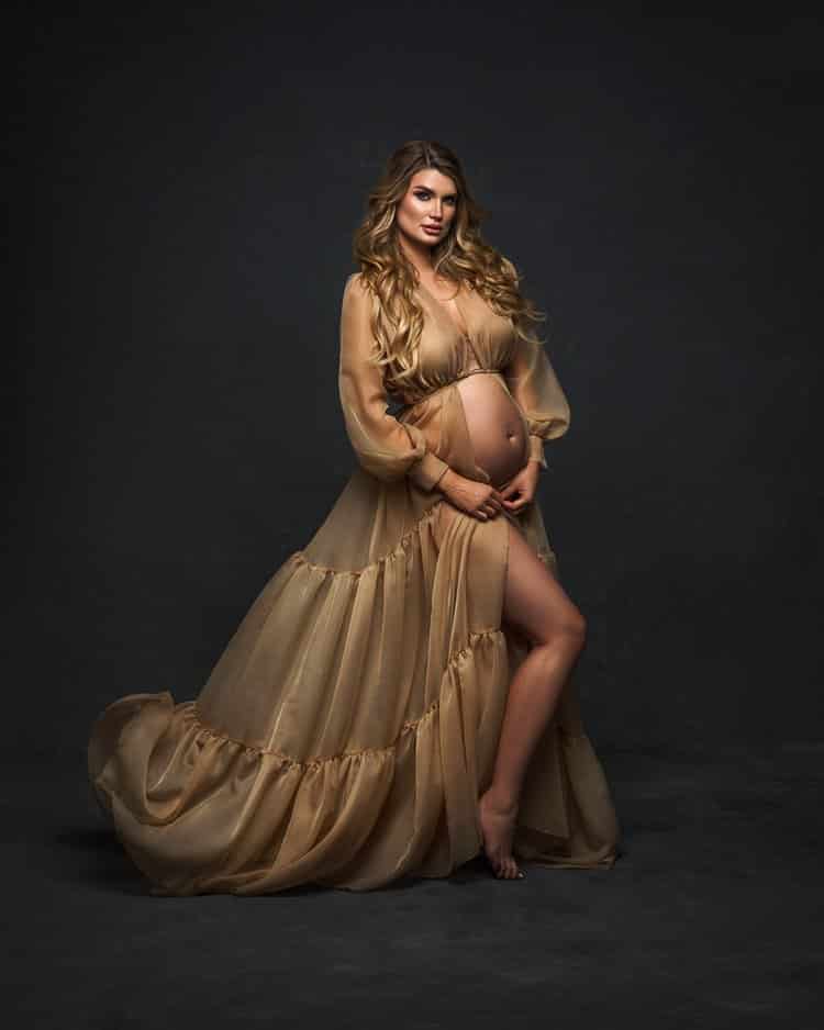 A pregnant woman in a blue dress poses for a picture Image & Design ID  0000268740 - SmileTemplates.com